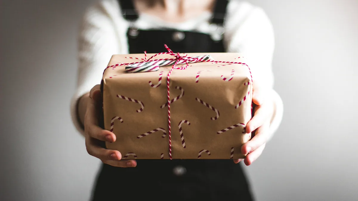 A personalized wooden crate styled with festive christmas eve box ideas for toddlers under the tree